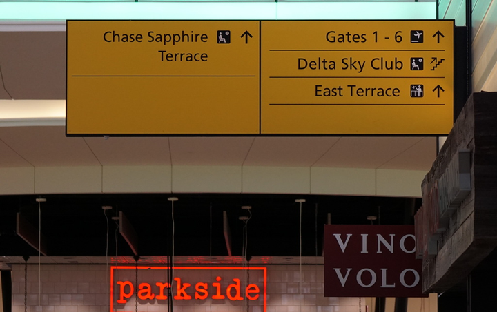 airport signs showing directions to lounge
