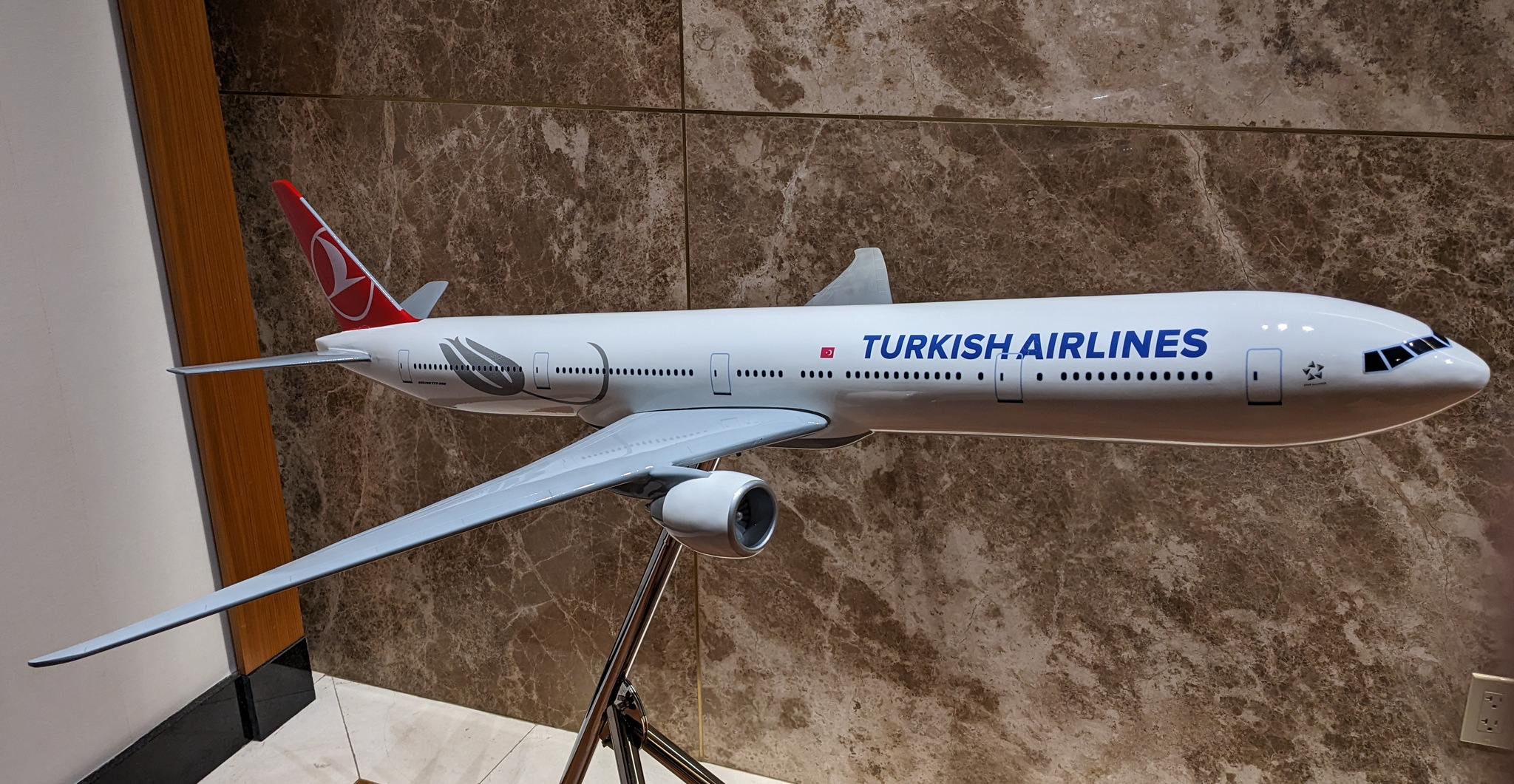 large Turkish Airlines (777) model plane in lobby of lounge.