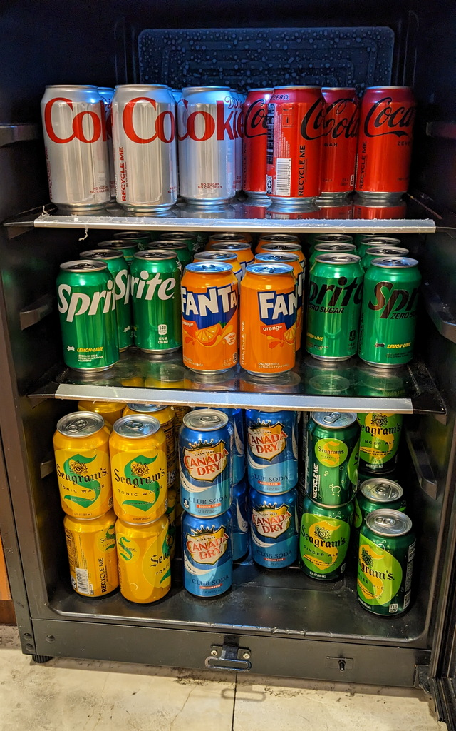 self-serve refrigerator with soda cans