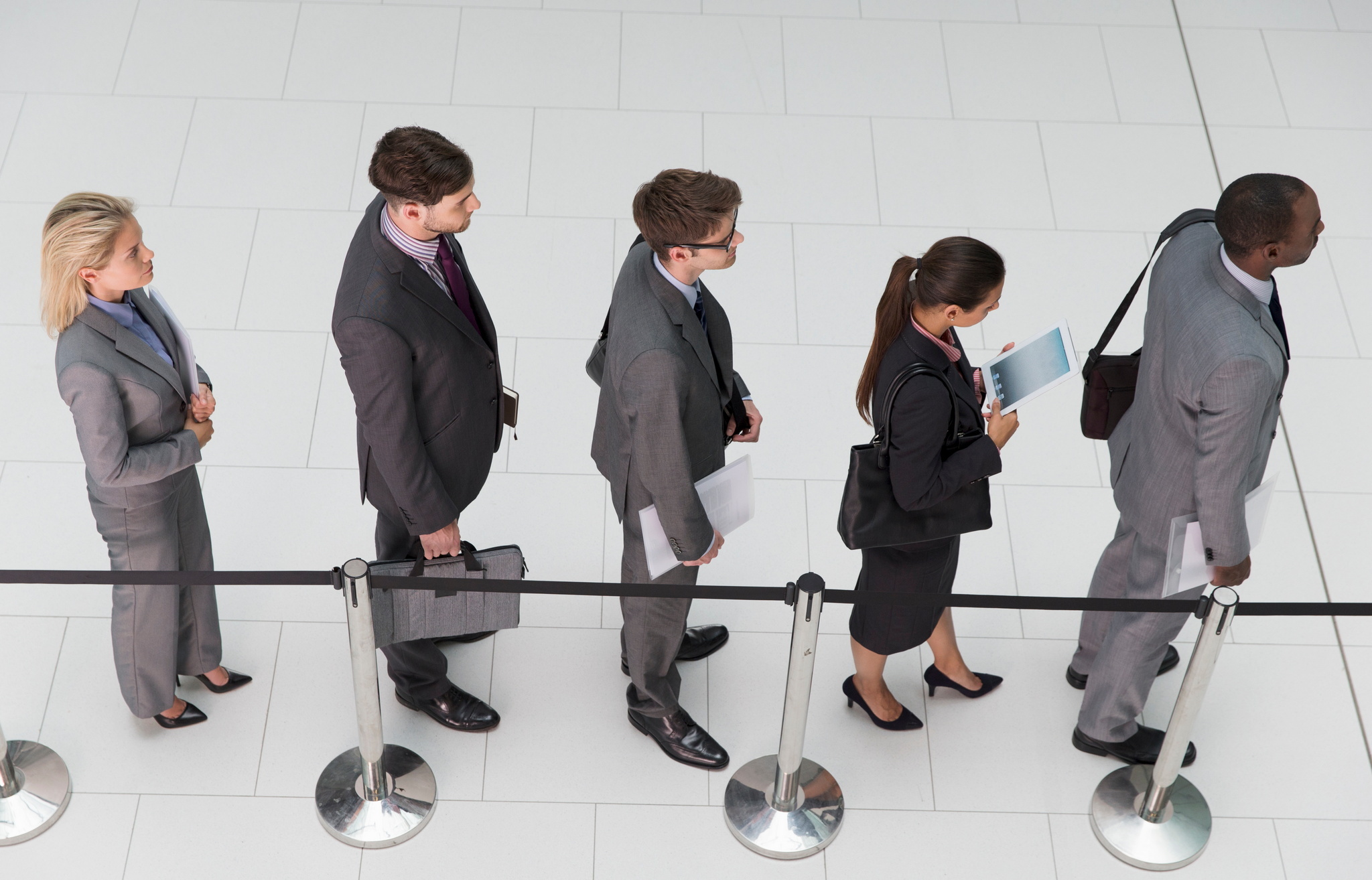 five dressed up people waiting in a line.