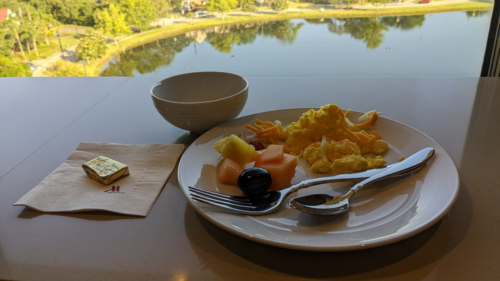 a plate of food with a view of the lake in the background.