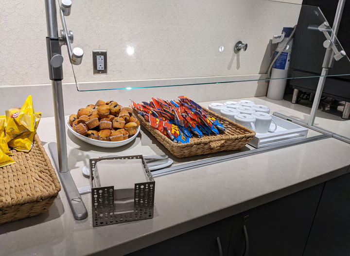 buffet area with chips, muffins and cookies.