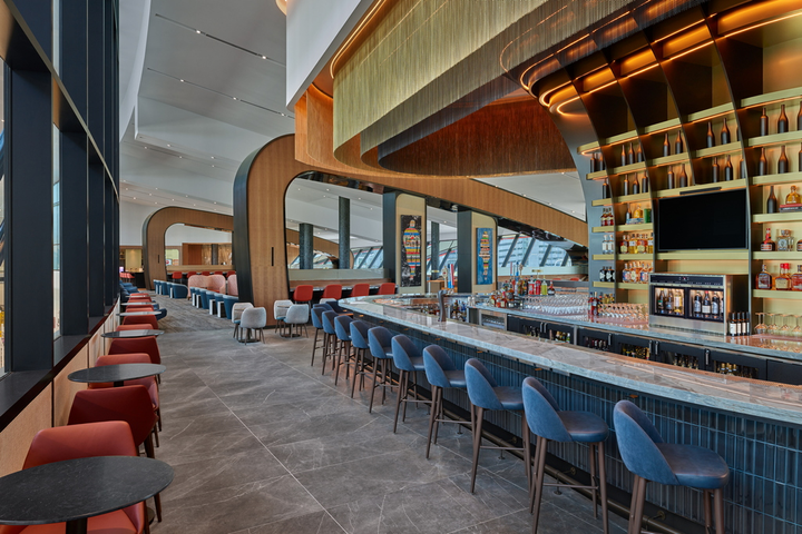 bar area and tables inside of the Boston Delta Sky Club