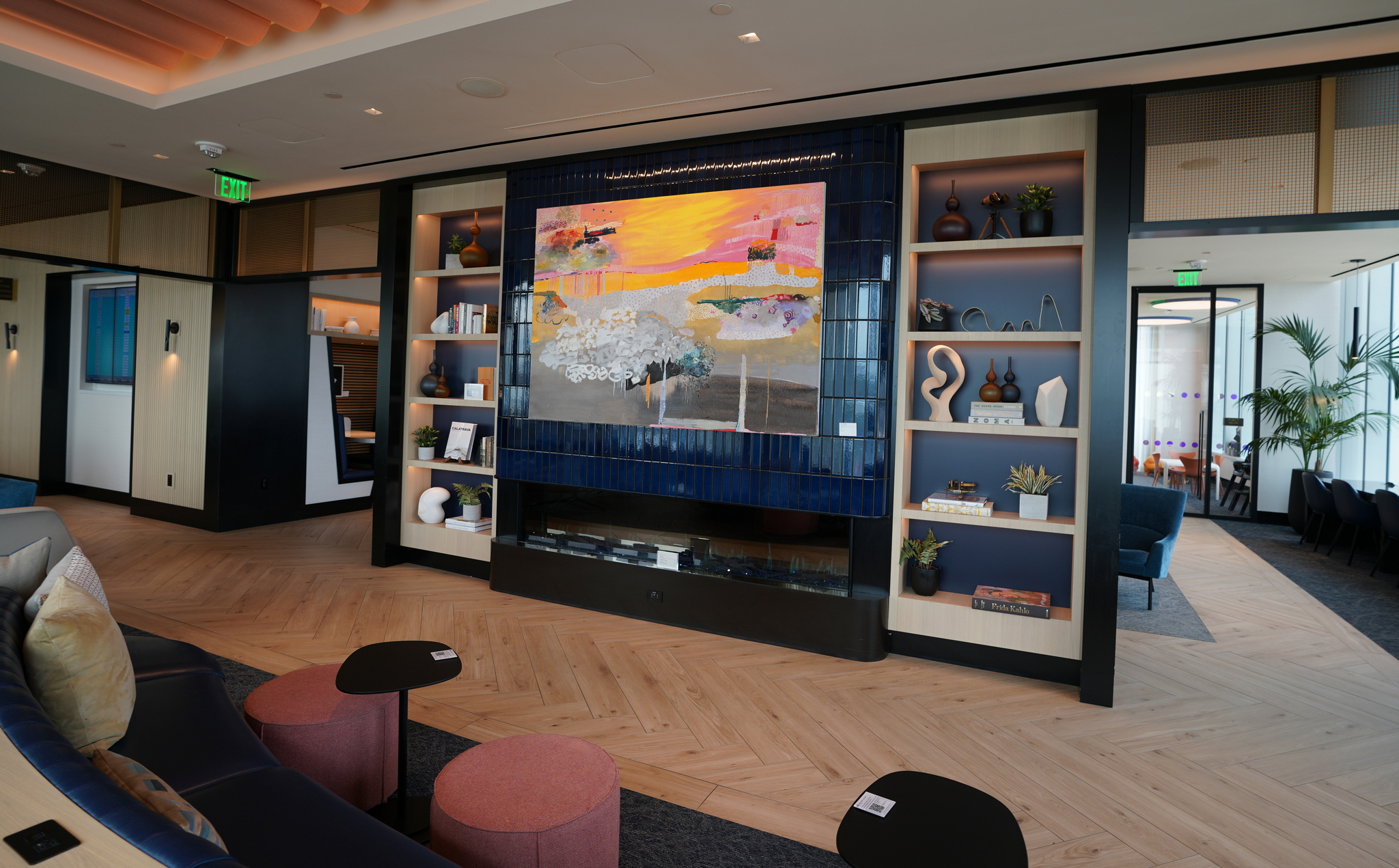 main seating area in the Chase Sapphire (BOS) lounge, with art on the walls.
