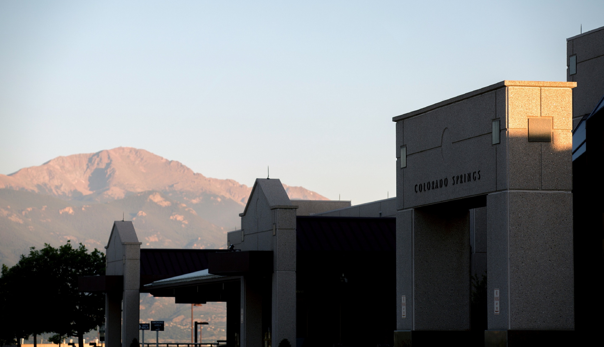 front entrance to Colorado Springs Airport with Mountains in background.