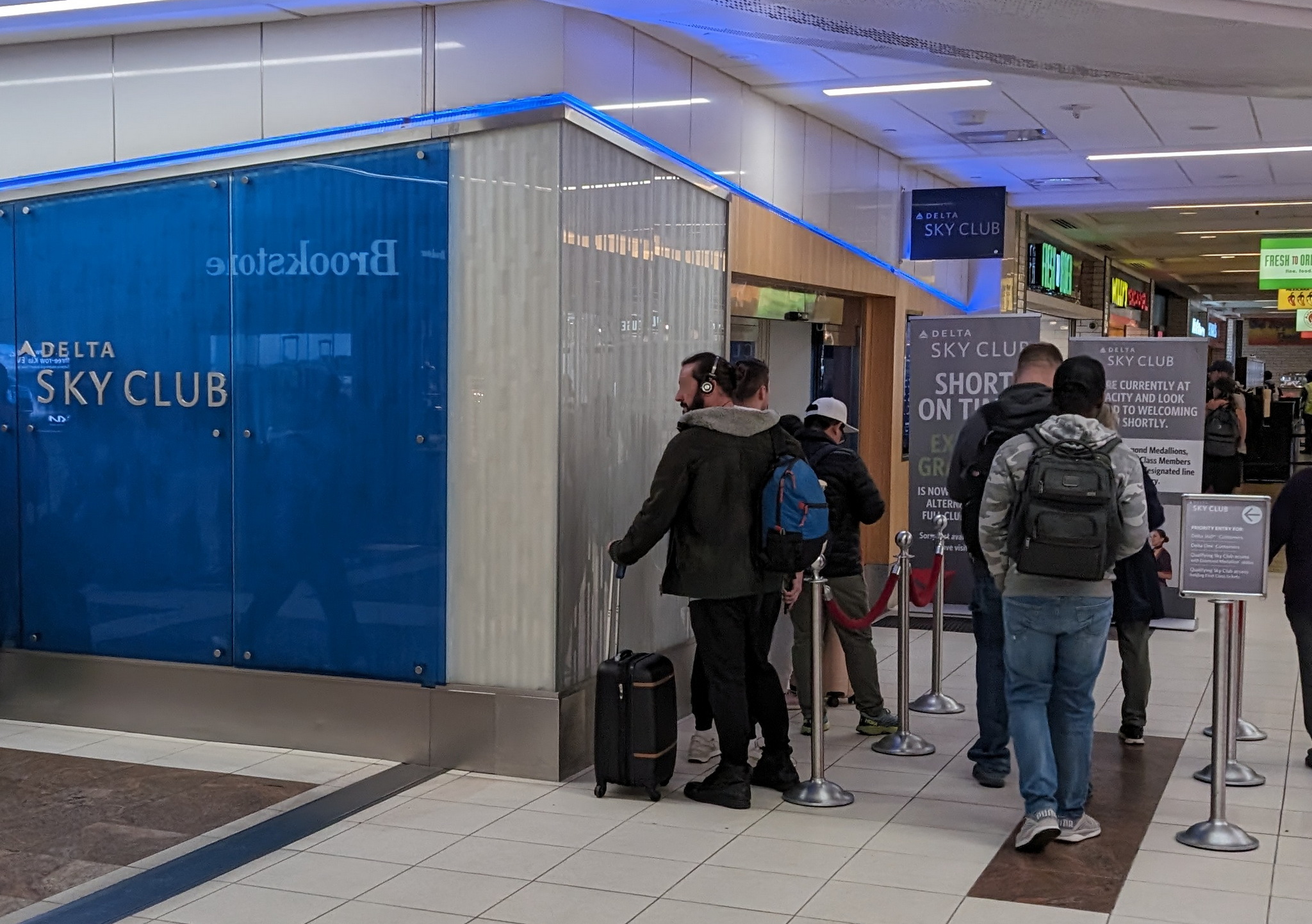 people waiting to enter a Delta Sky Club lounge in Atlanta.