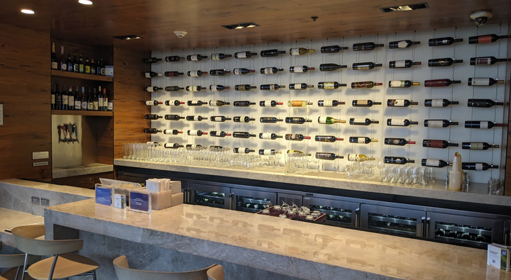 bar area with bottles of wine displayed in background.