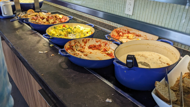 food buffet area, with several hot food items.