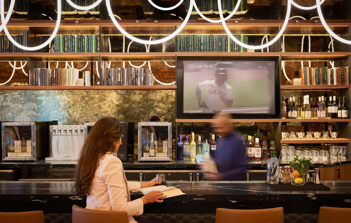 bar area with chairs and drinks.