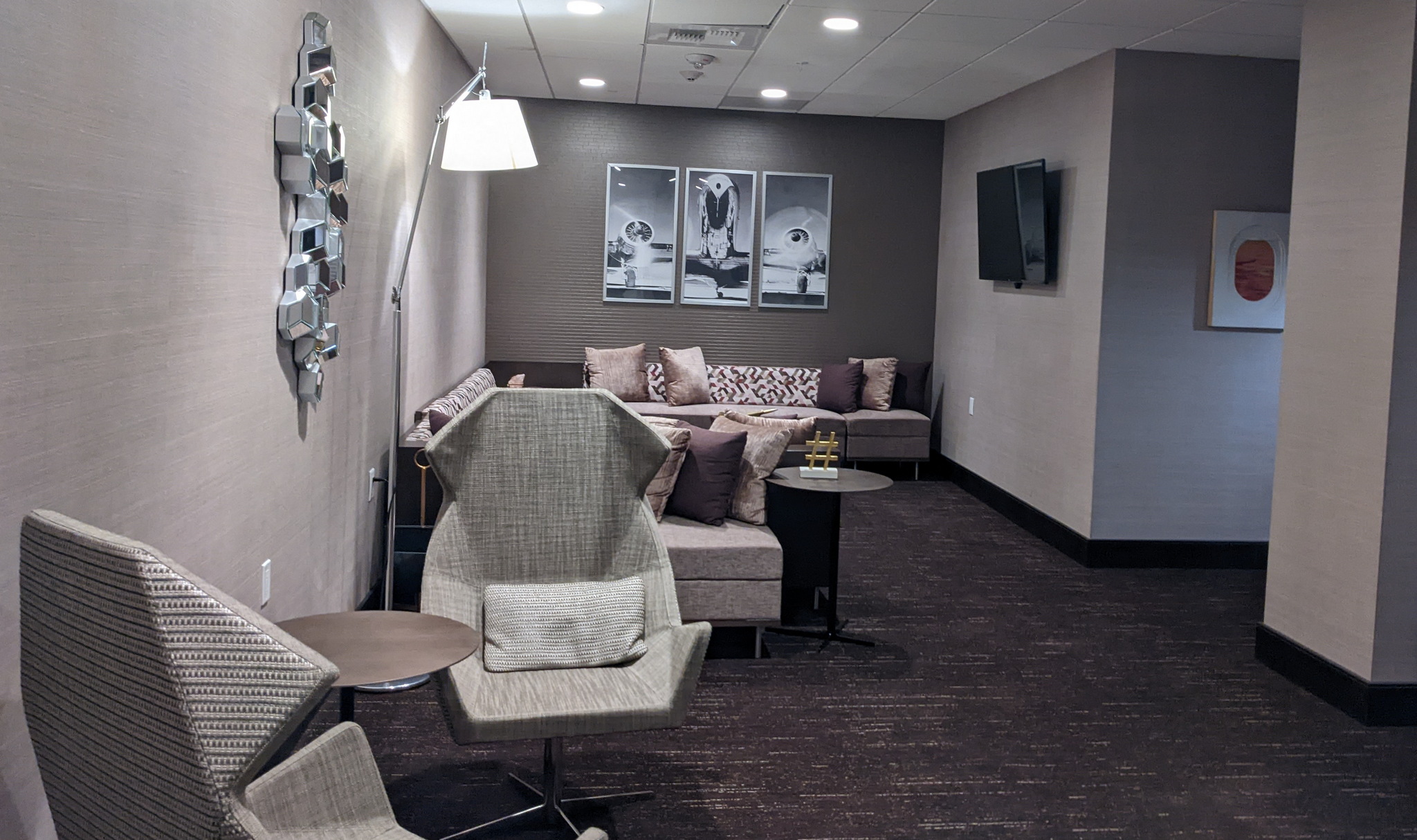 The Transfer Lounge lobby with chairs and TV