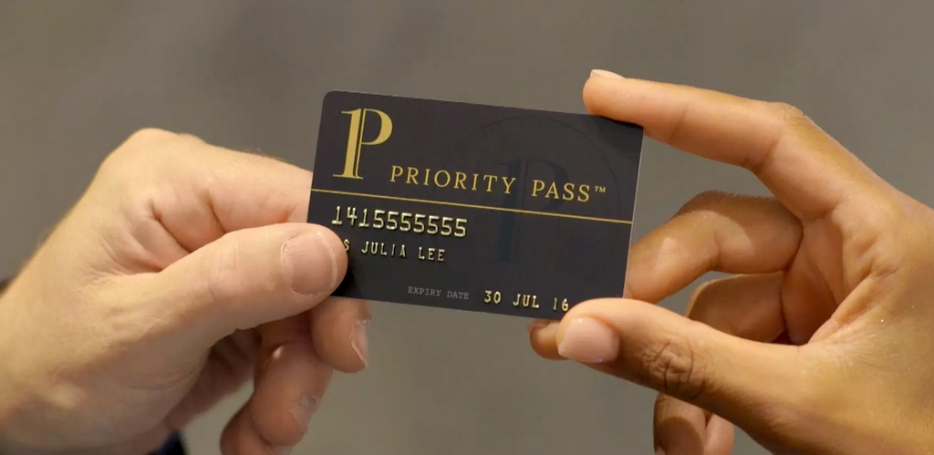 person holding a priority pass membership card