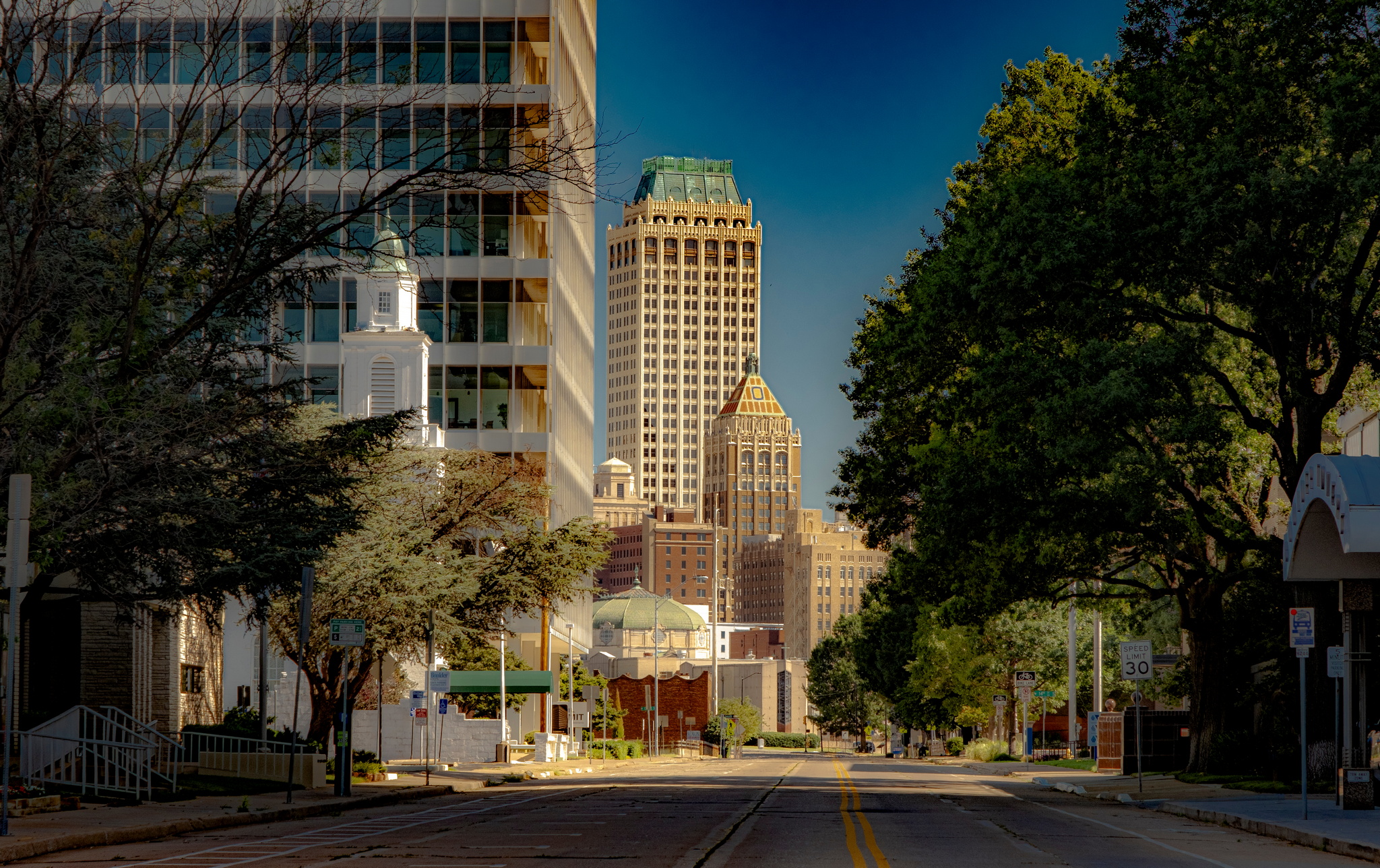 downtown Tulsa with buildings, trees, along a street.