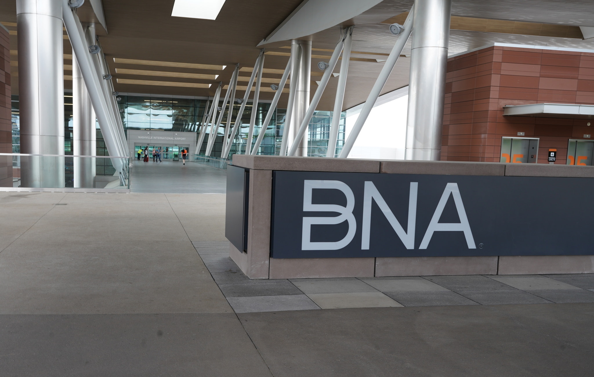 outside Nashville Airport with BNA sign end airport entrance.