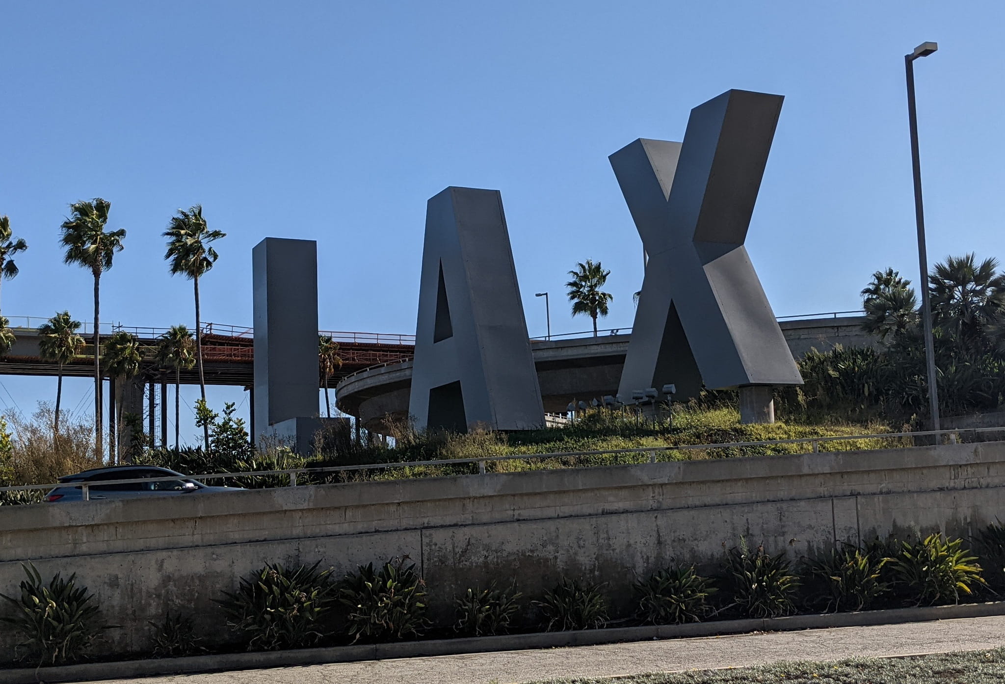 LAX entrance sign shows large silver letters L, A, X