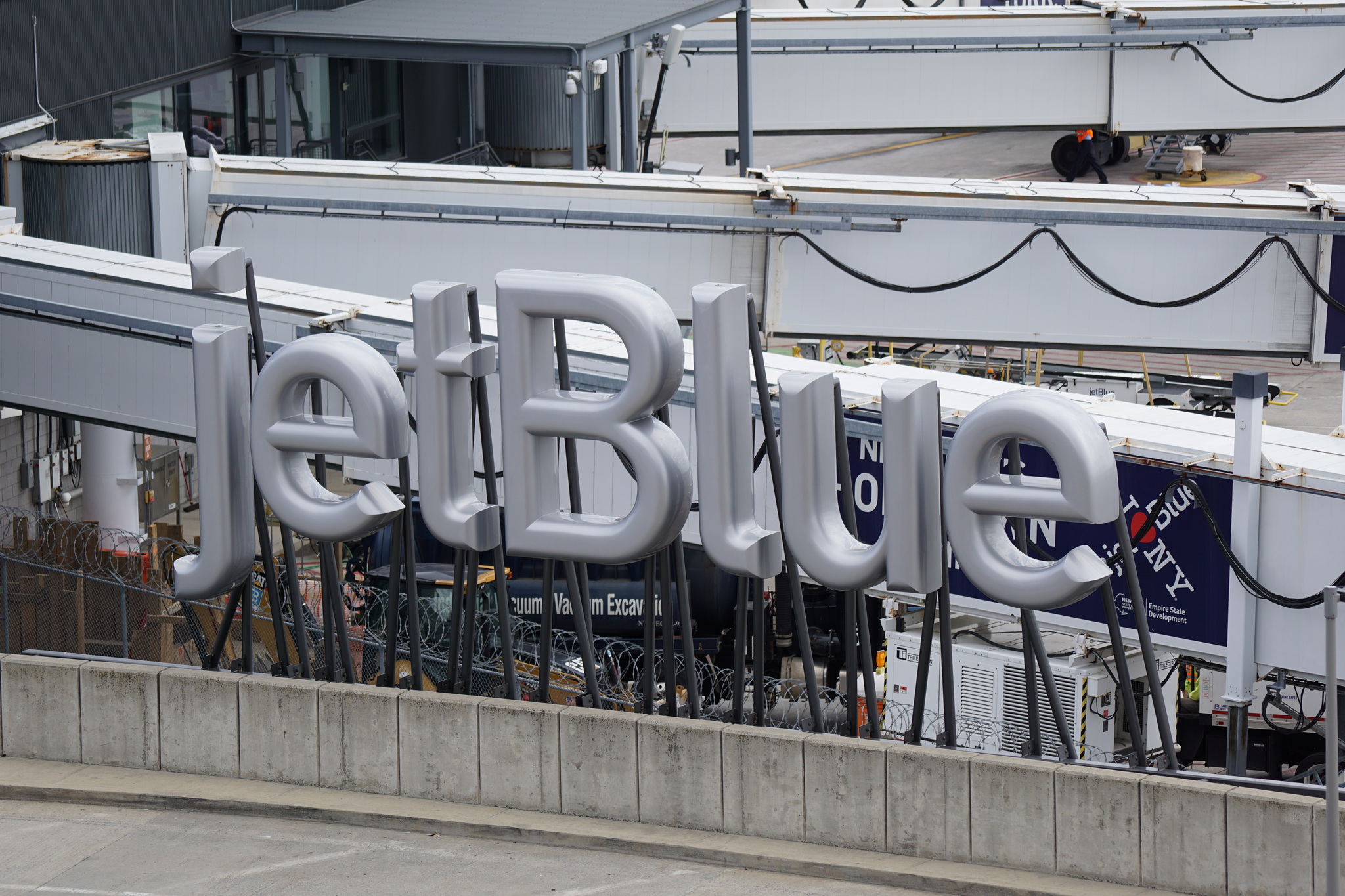 Silver jetBlue sign located at JFK airport.